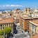 The cityscape of Cagliari with historic buildings and palm trees lining the streets